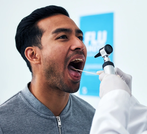 Man receiving dental examination from dentist in white coat at modern dental office