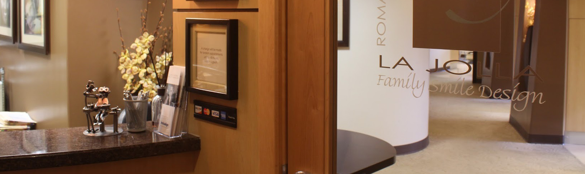 Modern dental office interior with warm brown tones, reception area, and elegant décor.